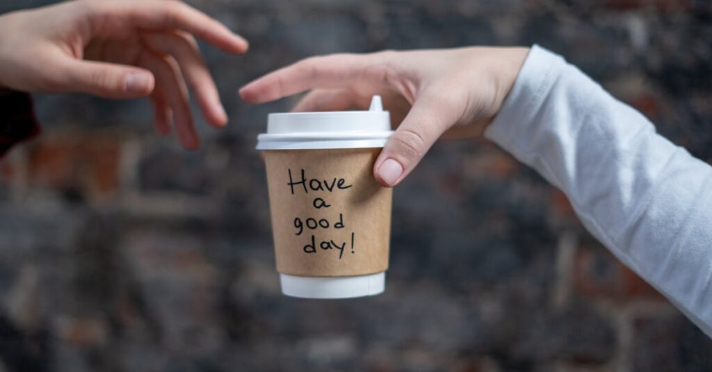 pexels-photo-3832259-3832259 Close-up shot of a disposable coffee cup with 'Have a good day!' message being passed between two hands.